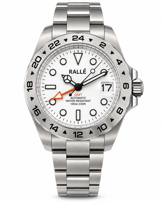 A stainless steel wristwatch with a white dial, black bezel markings, and a silver metal link bracelet. The dial features a white date window, black hour markers, and a distinctive orange accent hand.