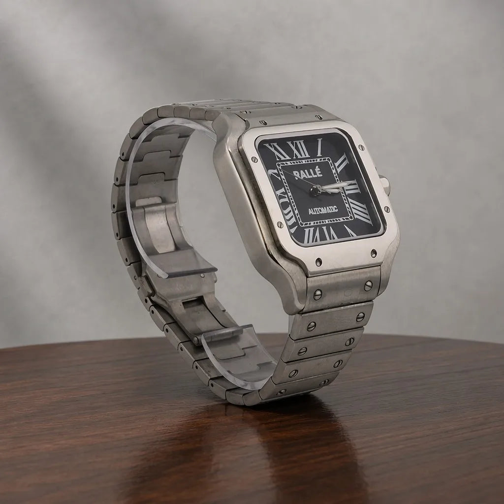 Close-up of Ralle Legacy Silver Automatic Watch with Black Dial on polished wood surface.