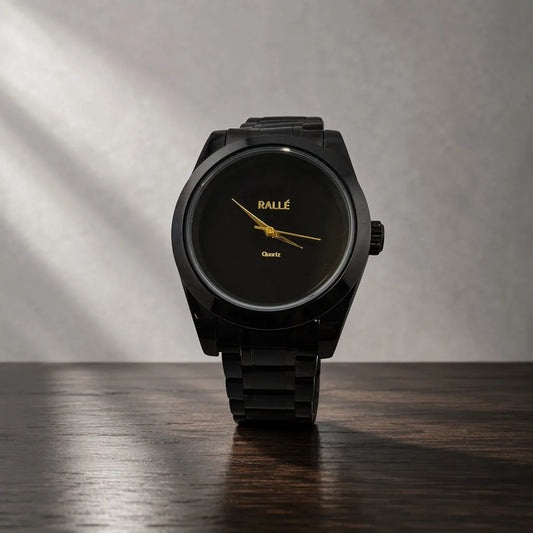 Rallé Men's Pure Time Black Case - Front view on dark wood surface showing minimalist matte black dial with gold-tone hands and black metal bracelet, reflecting refined craftsmanship and premium detail.